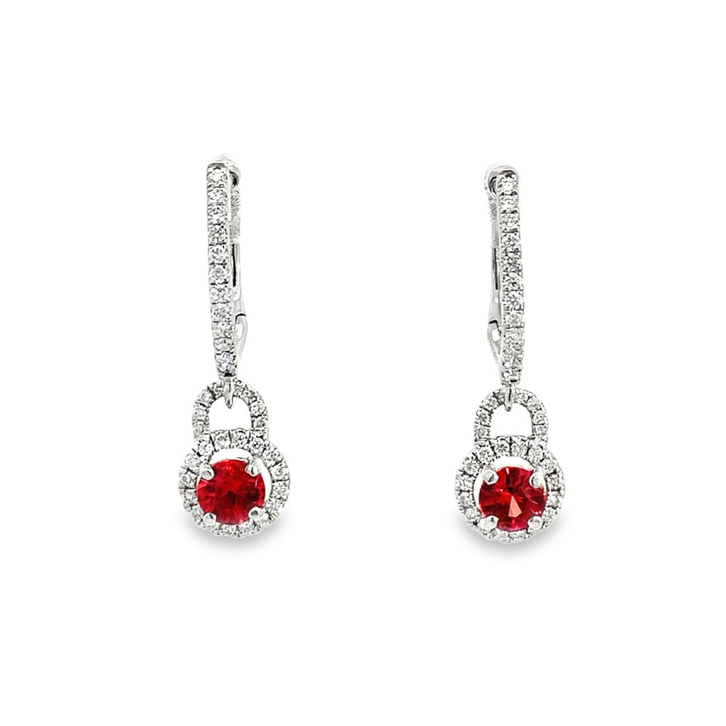Photo of a pair of diamond dangle earrings with a single round ruby Center on a white background