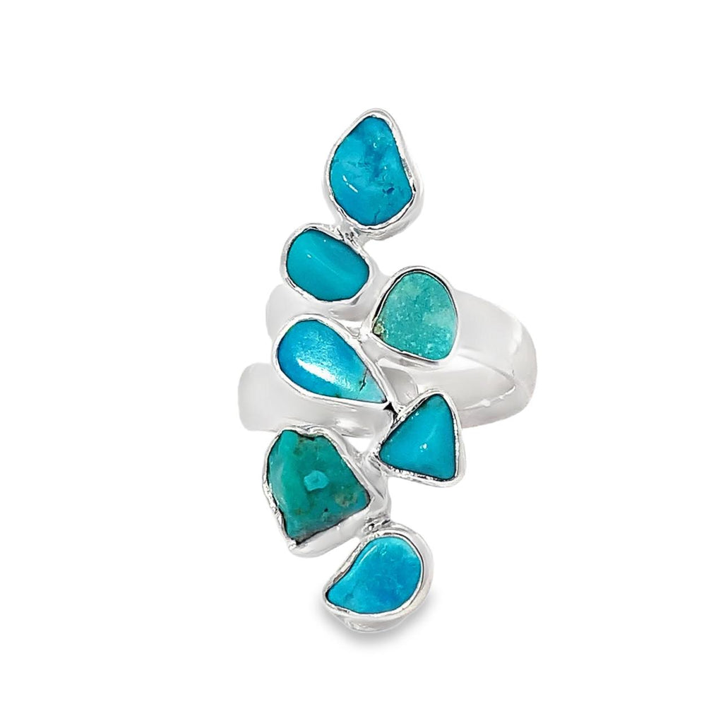 photo of a silver 7 stone turquoise ring on a white background
