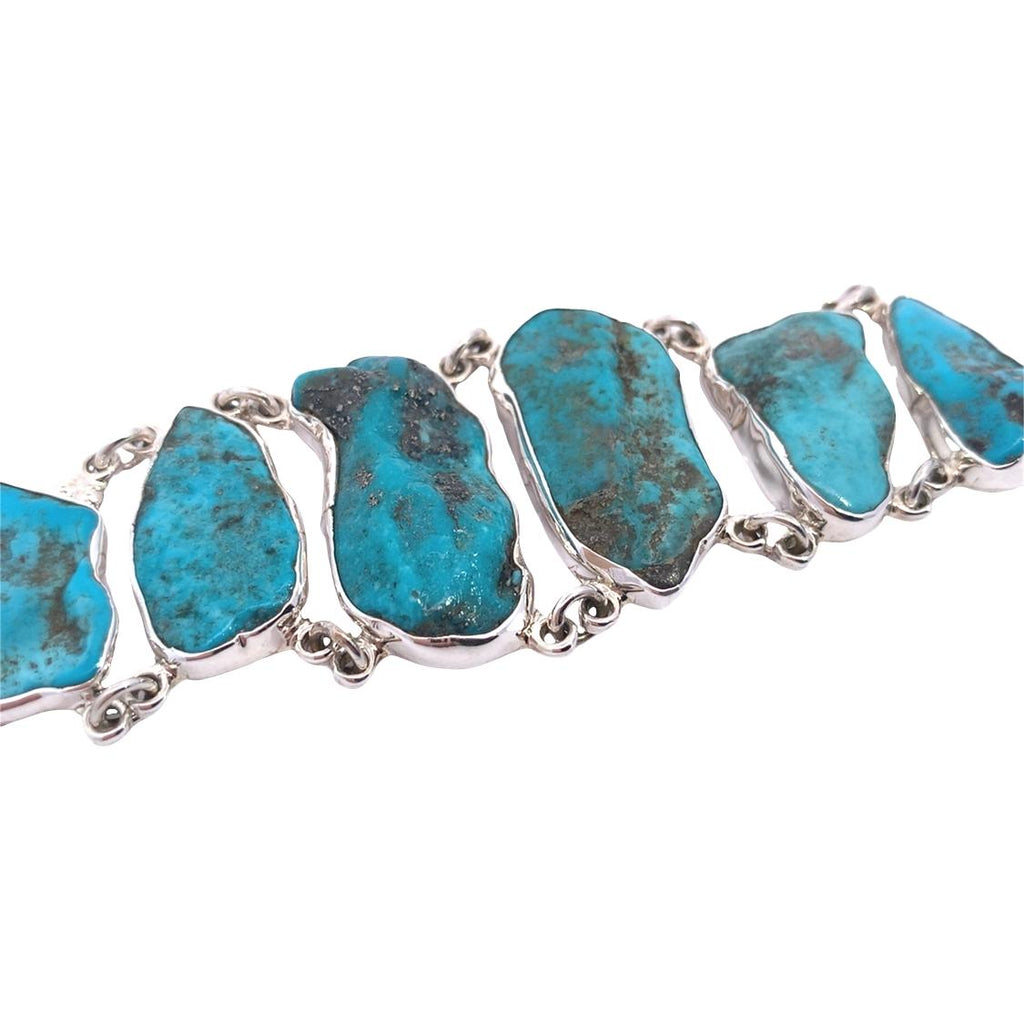 photo of a statement silver turquoise bracelet on a white background