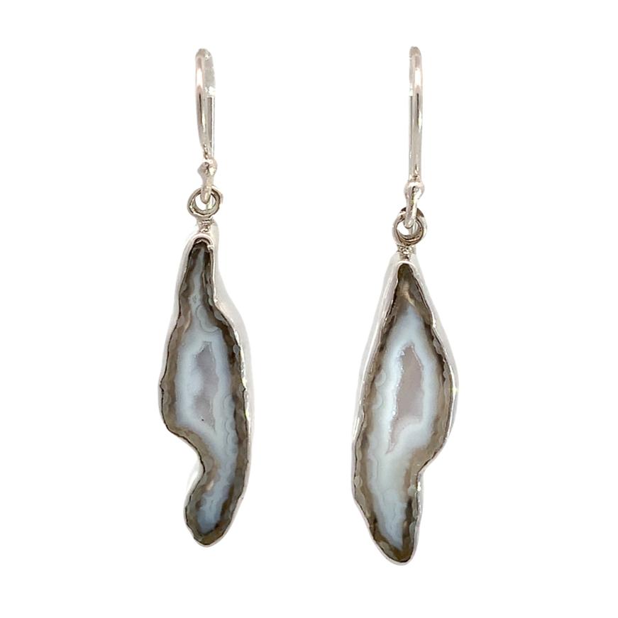 photo of a pair of silver bezeled long natural geode drop earrings on a white background