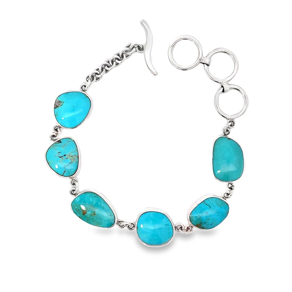 photo of a six gem bezel set turquoise link bracelet on a white background
