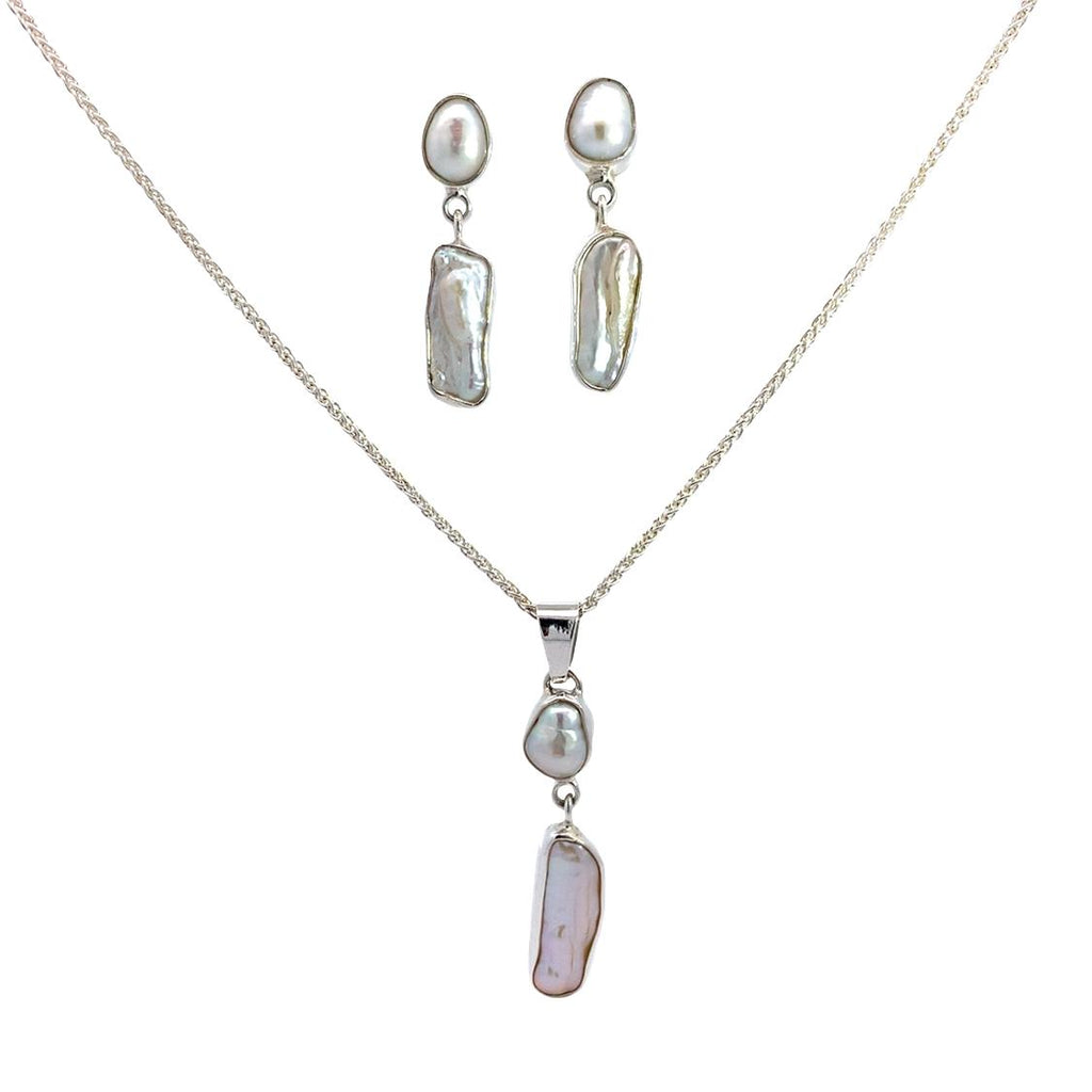 photo of a silver two-part long and oval bezel set white pearl set, which includes the earrings and a pendant on a white background