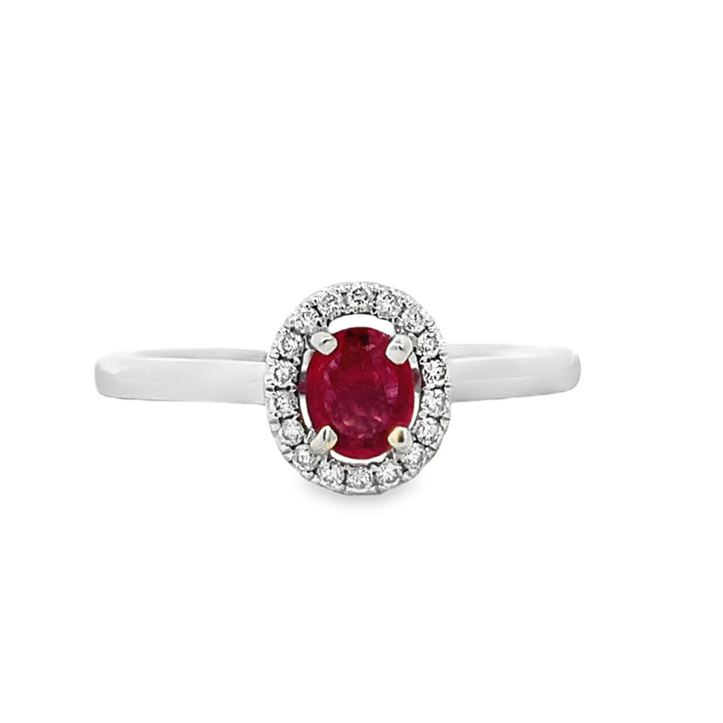 photo of a white gold diamond halo ring with a red oval spinel on a white background 